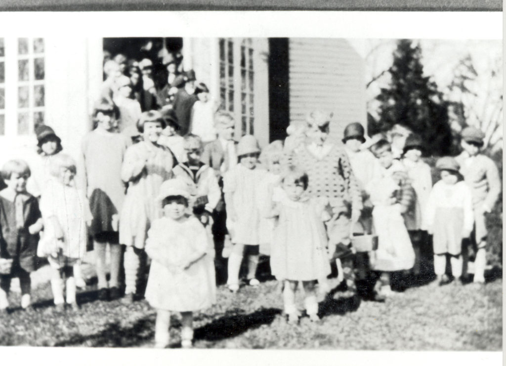 Well dressed kids posing for a picture outside.