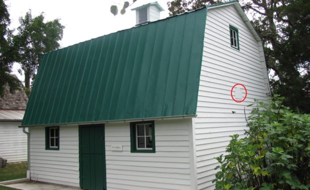 Hay loft sweep-out hatch